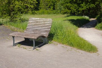 Wooden bench inviting visitors to relax in peaceful park