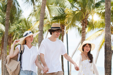 Obraz premium Group of diverse ethnicity people are enjoy walking together on the beachside street.
