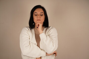 A woman arms crossed on her breast, symbolizing confidence and perseverance. Her posture conveys unwavering commitment. The woman stands confidently and smiling.