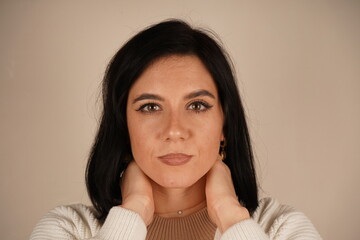 A woman arms crossed on her breast, symbolizing confidence and perseverance. Her posture conveys unwavering commitment. The woman stands confidently and smiling.