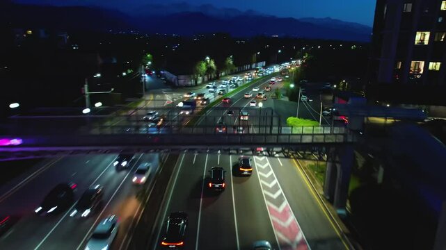 Drone shot of busy multilane road with cars at night