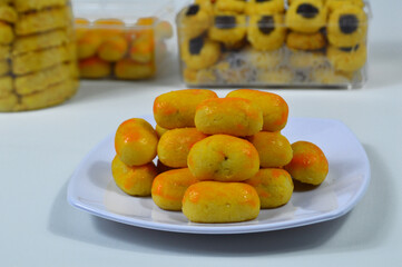 Kue nastar or pineapple tart. indonesian eid snack (kue lebaran). on a white plate. bright mood style. perfect for recipe, article, catalogue, or any commercial purposes.
