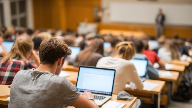 College Students Using Laptops in a Lecture Hall Focused on Learning