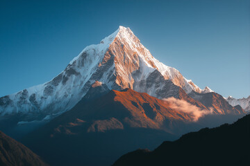 A snow-covered mountain peak with clouds swirling around it. 