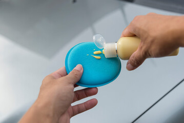 The man Wax and polish the car by hand   