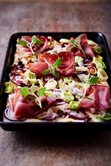 Pizza with ham, mozzarella cheese and leek. Close up.	