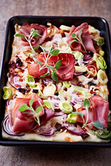 Pizza with ham, mozzarella cheese and leek. Close up.