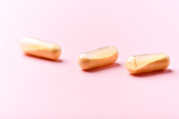 Coenzyme Q10 capsules. Antioxidants. Concept for a healthy dietary supplementation. Bright background. Soft focus. Close up. Copy space.