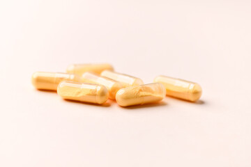 Coenzyme Q10 capsules. Antioxidants. Concept for a healthy dietary supplementation. Bright background. Soft focus. Close up. Copy space.