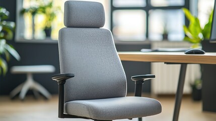 Fototapeta premium A soft fabric office chair with a medium-high backrest and deep seat cushions for comfort.