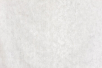 Blurred studio gray fabric background.