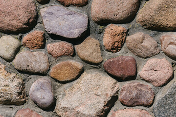 Close-up of the texture of a cobblestone made from mountain building stone.