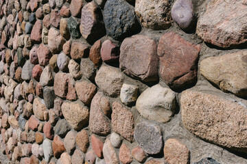 Close-up of the texture of a cobblestone made from mountain building stone.