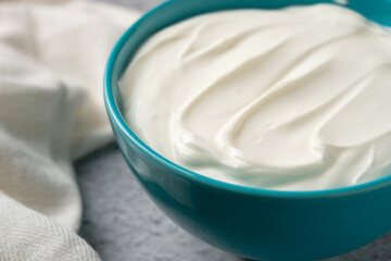 Top view of yogurt in bowl on grey stone table. Healthy eating concept