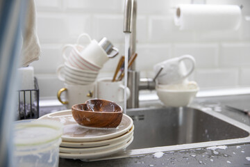 Dirty soapy dishes on the kitchen sink