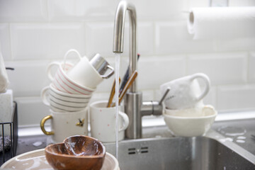Dirty soapy dishes on the kitchen sink
