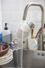 Dirty soapy dishes on the kitchen sink