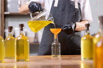 Craft fresh sunflower oil bottling in glasses bottle on eco food manufacturing