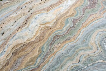 Colorful stone wall texture shows an old, grunge pattern with aged paint