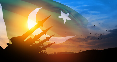 The missiles are aimed at the sky with birds at sunset with Pakistan flag. Nuclear bomb, chemical...