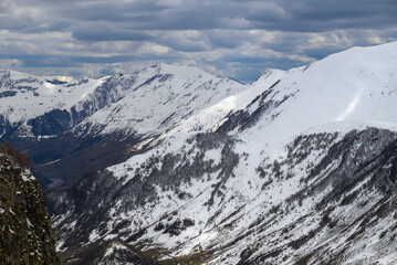 Fototapeta premium Snowcapped peaks of Caucasus mountains along the Georgian Military Road, major route from Georgia to Russia