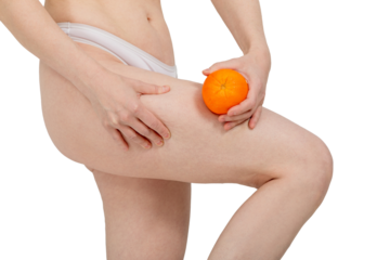 Woman puts orange on skin and pinches her thigh to see cellulite