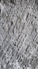 Texture of rough concrete wall with visible patterns and grooves at construction site during daytime