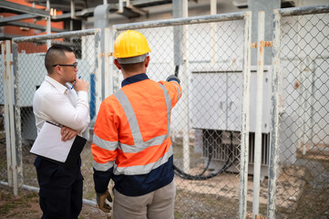 Electrical engineers check the operation of electrical transformers for industrial buildings