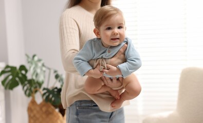 Mother with her cute little baby at home, closeup