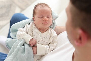 Father with his cute newborn baby indoors, above view