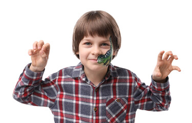 Cute boy with dinosaur face painting posing on white background
