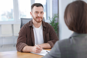 Recruiter and candidate having job interview at desk in office