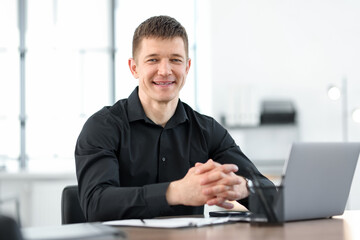 Obraz premium Portrait of handsome man at desk in office