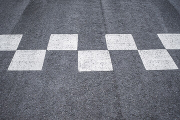 Close-up of road markings at the race start and finish.