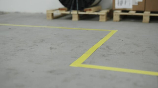 Yellow floor marking line inside an industrial environment symbolizes safety, order, and guidance