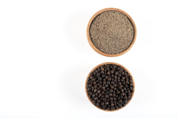 Ground black pepper with grains of black pepper on white  background