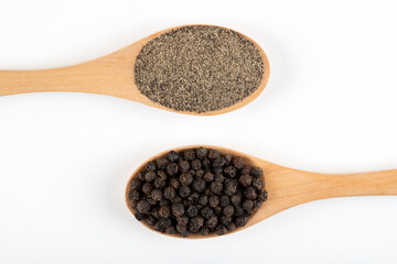 Ground black pepper with grains of black pepper on white  background