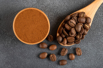 Coffee beans with a bowl of ground coffee on gray background
