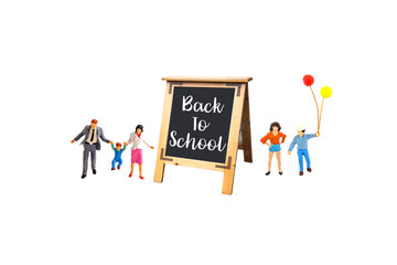 miniature people with blackboard isolated on white background.