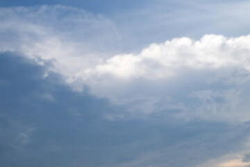 High nature view large white clouds on soft sky background in the morning, View of white cloudy on the plane. Dark and white two clouds met in the center