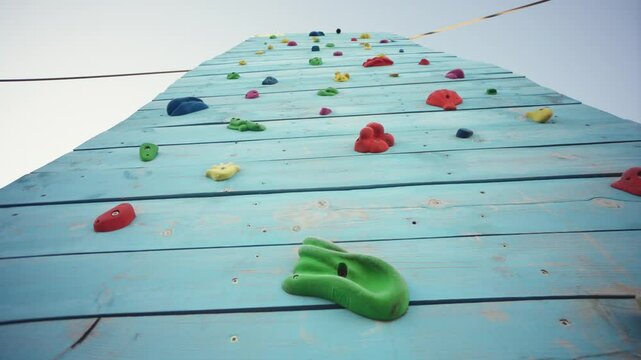 Empty climbing wall in a climbing center adventure park with colorful grips