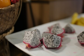 dragon fruit slice on fruit peel with pitahaya background , fresh white dragon fruit tropical in...