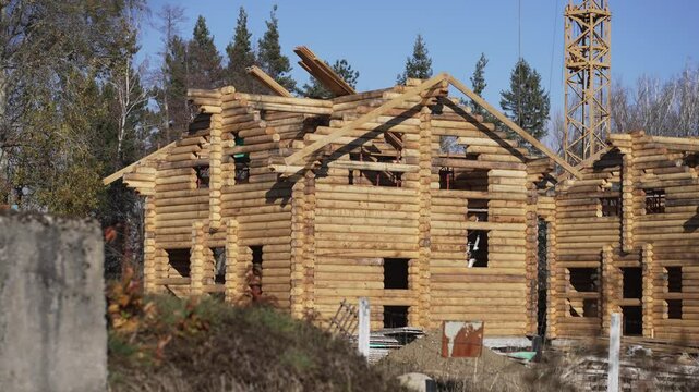 Drying and assembly of wooden log house at a construction base, industrial backgorund