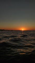 Obraz premium Sunset over adriatic sea reflecting on calm waves in croatia during summer vacation