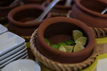 bowl with limes on light stone background top view. Copy space for your design. High quality photo
