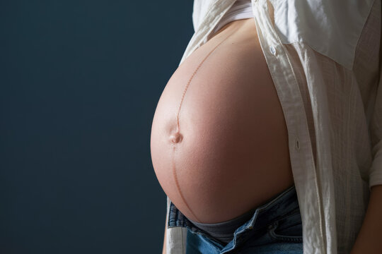Pregnant woman with visible linea nigra.