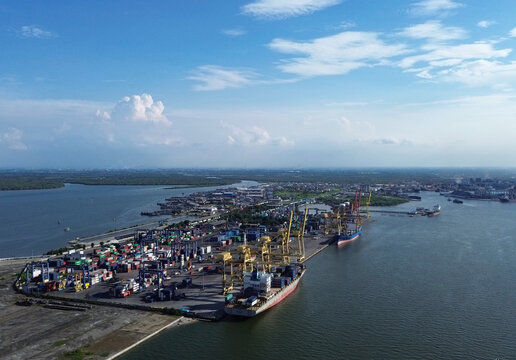 Aerial view of Belawan Port in Medan, Indonesia, showing cargo containers, cranes, and port activities. Shot on April 21, 2025