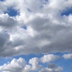 Obraz premium Sky with with gray and white beautiful clouds. Background. Cloudscape has been developing in gorgeous form. The picture present a beautiful cumulus clouds.