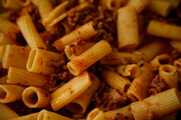 Delicious tortiglioni pasta with bolognese sauce filling frame