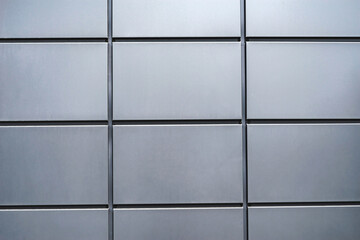Close-up, texture of a metal panel of a modern building. Abstract backgrounds for design.